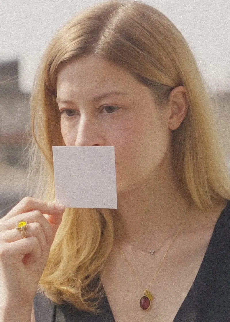 Portrait of Claire Liégent smelling a blotter